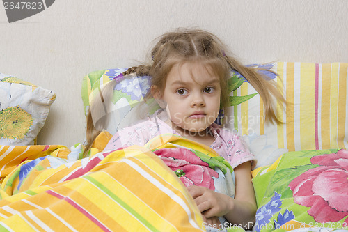 Image of Four-year-old girl is in bed under the blanket