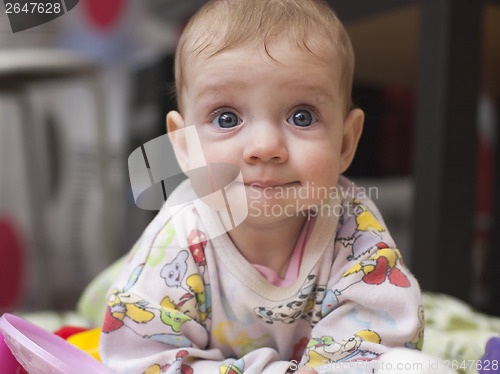 Image of six-month baby with a fun look at home