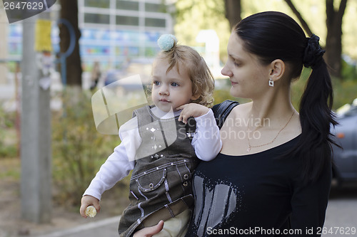 Image of My mother is in hands of girl who eats banana