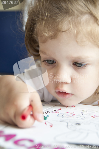 Image of Girl draws a pencil on sheet of paper