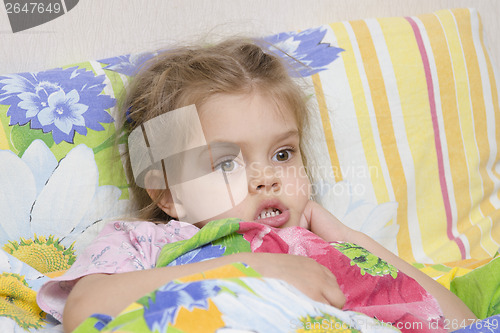 Image of Four-year-old girl is in bed under the blanket