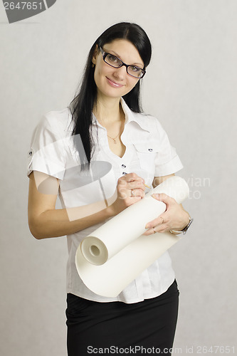 Image of girl wrote in pencil on the roll of paper