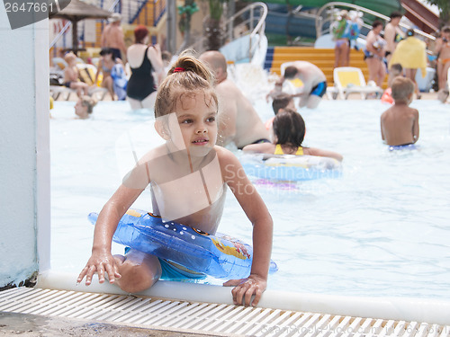 Image of Four-year-old girl gets out pool with tterms of