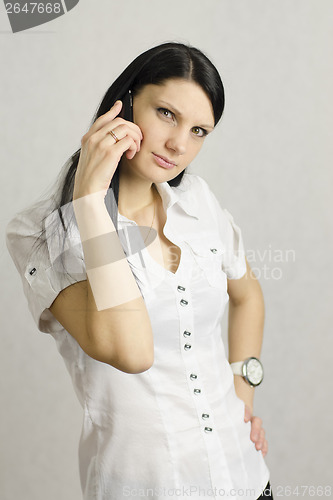 Image of girl questioning looks in frame talking on phone