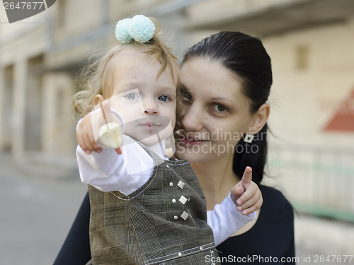 Image of My mother is in hands of girl who eats banana