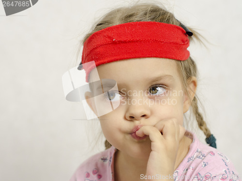 Image of Girl bites his nails enthusiastically looking left