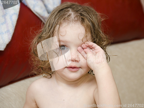 Image of Baby wipes his eyes after swimming handle