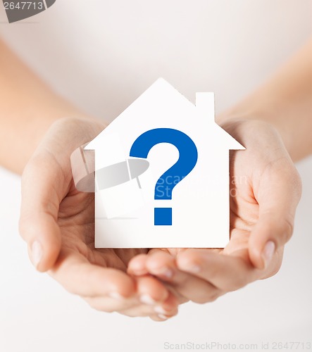 Image of hands holding house with question mark