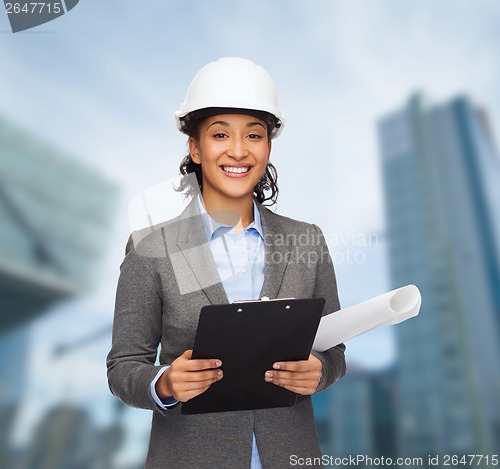 Image of businesswoman in white helmet with clipboard