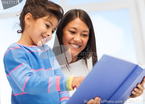 Image of mother and daughter with book
