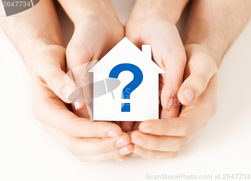 Image of hands holding house with question mark