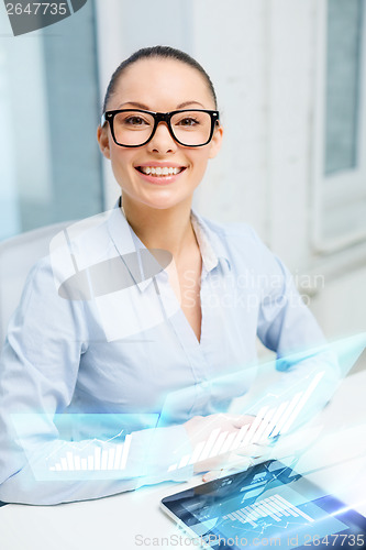 Image of smiling businesswoman in eyeglasses with tablet pc