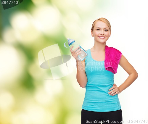Image of sporty woman with towel and watel bottle