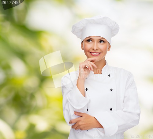 Image of smiling female chef dreaming