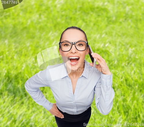 Image of happy businesswoman in eyeglasses with smartphone