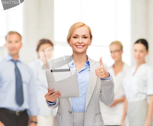 Image of smiling woman with tablet pc showing thumbs up
