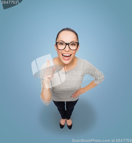 Image of asian woman in eyeglasses with finger up