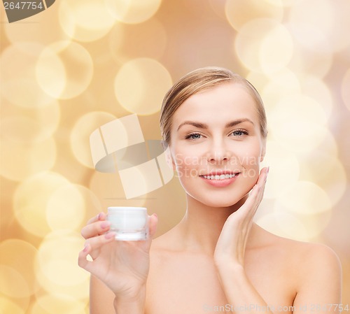 Image of woman applying cream on her skin