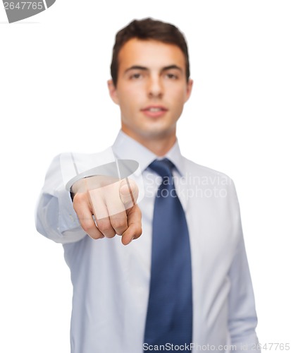 Image of friendly young buisnessman pointing finger