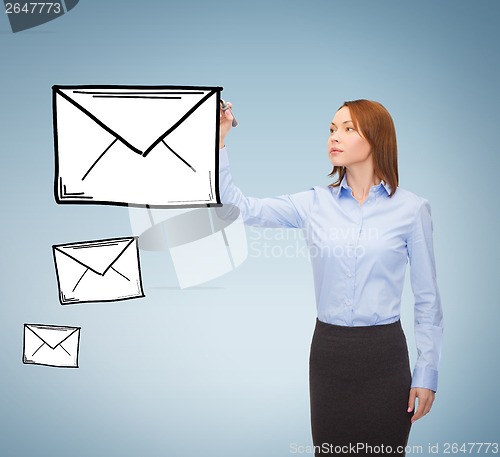 Image of businesswoman drawing envelope on virtual screen
