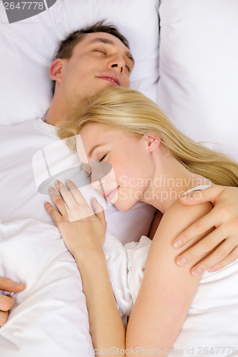 Image of happy couple sleeping in bed