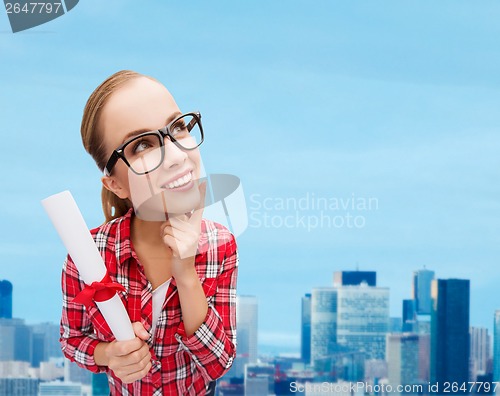 Image of smiling woman in black eyeglasses with diploma