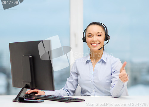 Image of female helpline operator showing thumbs up