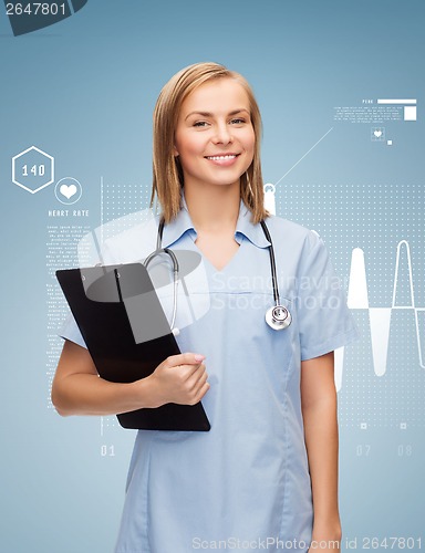 Image of smiling female doctor or nurse with clipboard