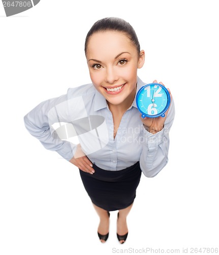 Image of smiling businesswoman with blue clock