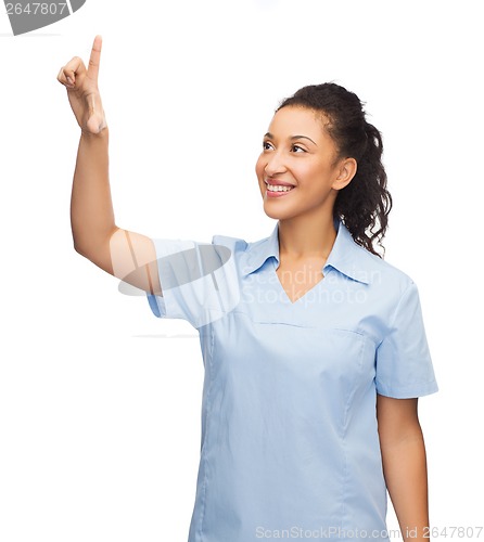 Image of smiling doctor or nurse pointing to something