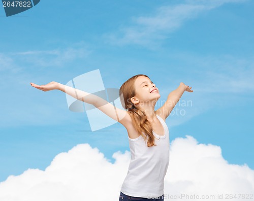 Image of smiling teenage girl with raised hands