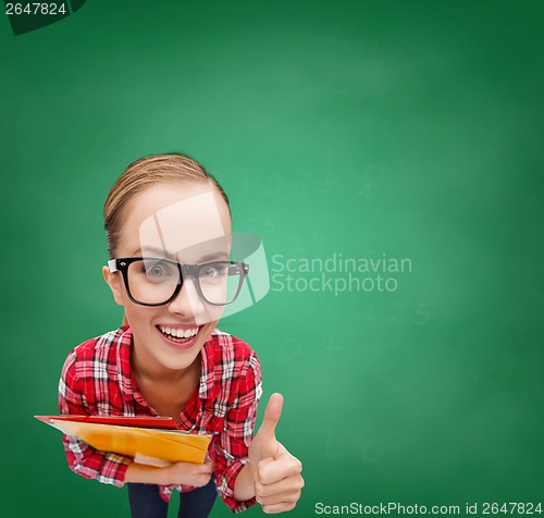 Image of student in glasses with folders showing thumbs up