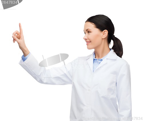 Image of smiling female doctor pointing to something