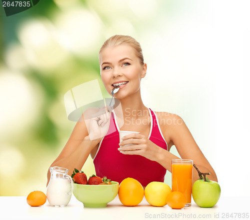 Image of young woman eating healthy breakfast