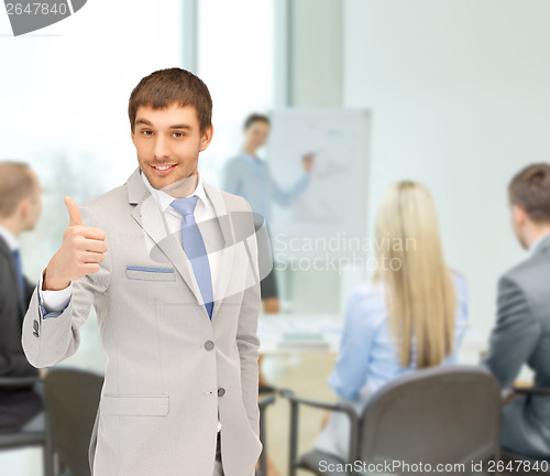 Image of businessman showing thumbs up