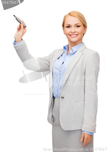 Image of businesswoman writing something in air with marker