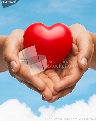 Image of womans cupped hands showing red heart