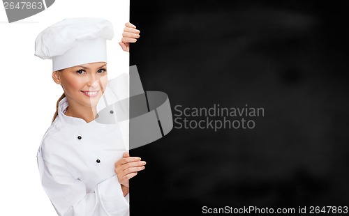 Image of smiling female chef with white blank board