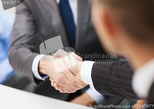 Image of two businessmen shaking hands in office