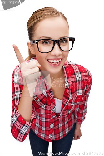 Image of smiling teenager in eyeglasses with finger up