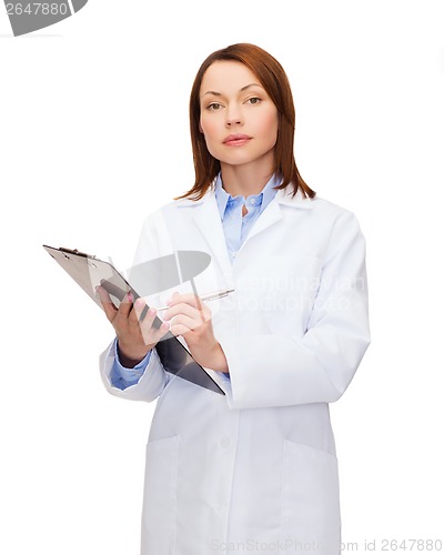 Image of smiling female doctor with clipboard