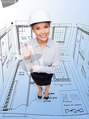Image of businesswoman in white helmet with finger up