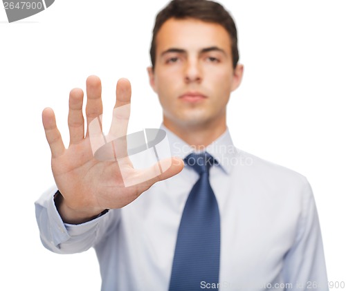 Image of attractive buisnessman making stop gesture