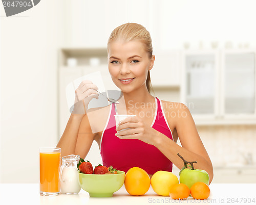 Image of young woman eating healthy breakfast