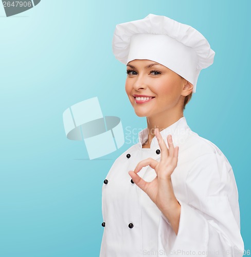 Image of smiling female chef showing ok hand sign