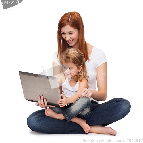 Image of happy mother with adorable little girl and laptop