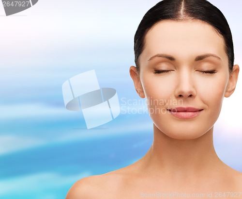 Image of young calm woman with closed eyes