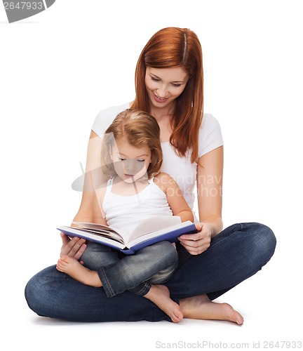 Image of happy mother with adorable little girl and book