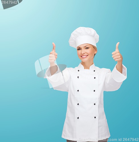 Image of smiling female chef showing thumbs up