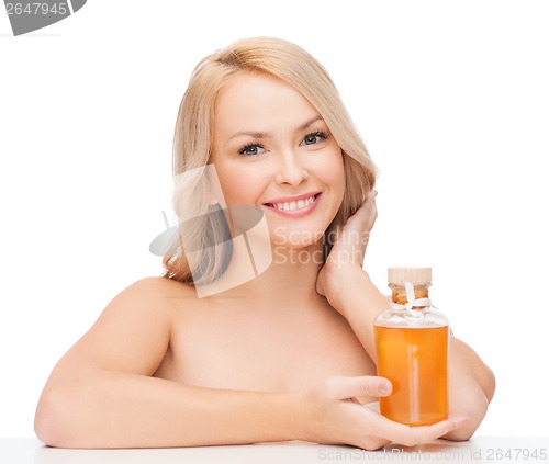 Image of happy woman with oil bottle